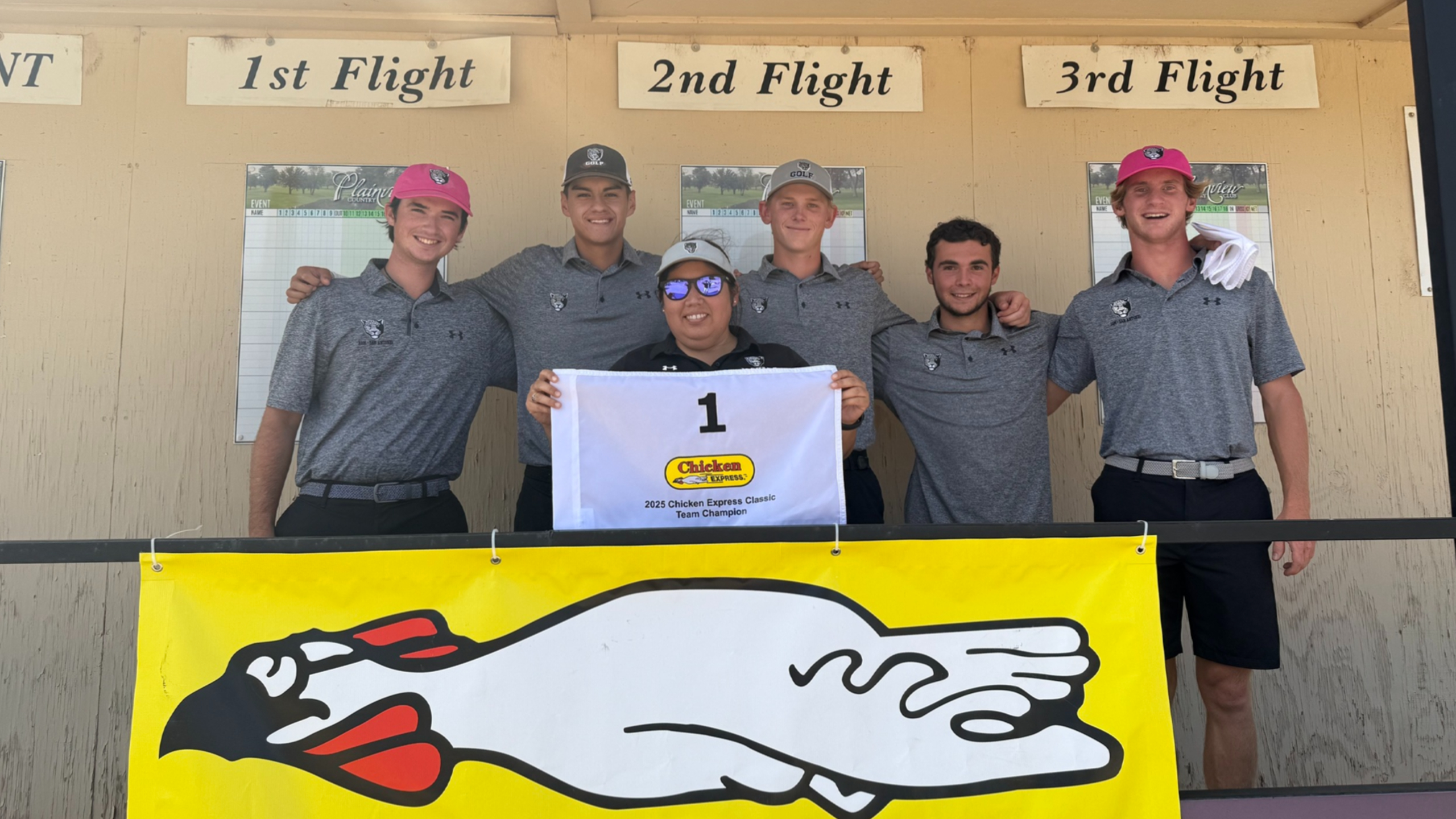 Players and Coach holding Flag symbolizing their first win.