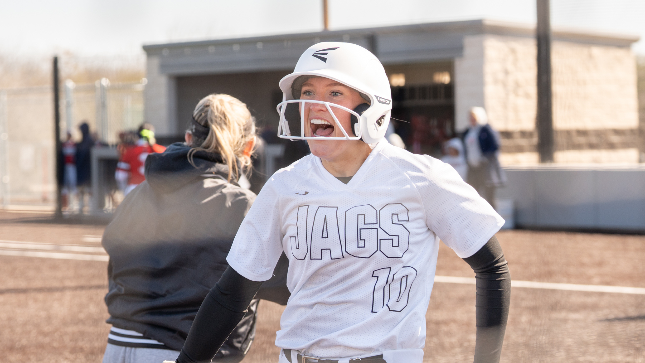 Softball player screaming in excitement from winning a double header.